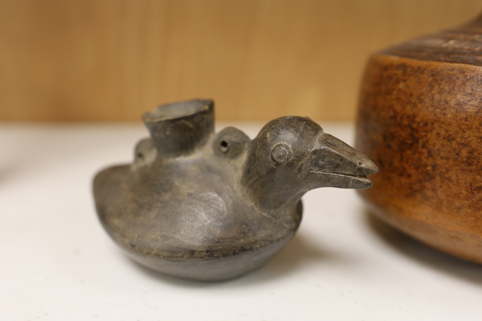 A black pottery bird vessel, probably pre-Columbian and a burnished terracotta jug, largest 15cm high. Condition - good for age